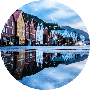 Decorative photo of a row of houses and a street with puddles reflecting them.