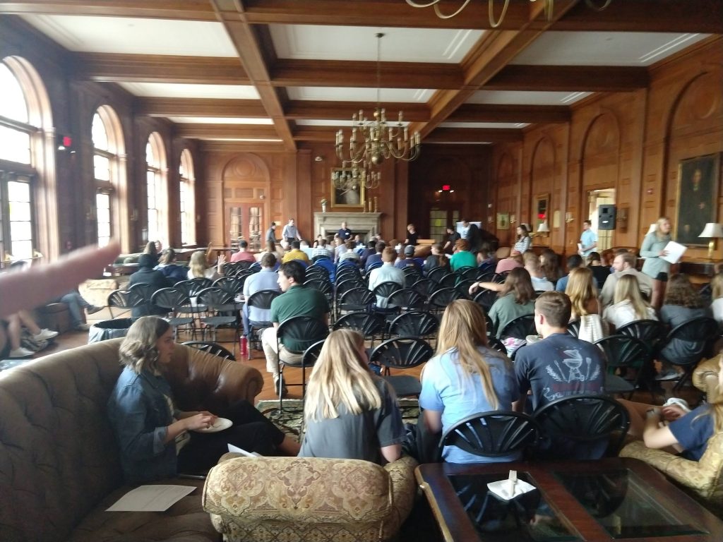An audience listens to a panel in Graham Memorial building.